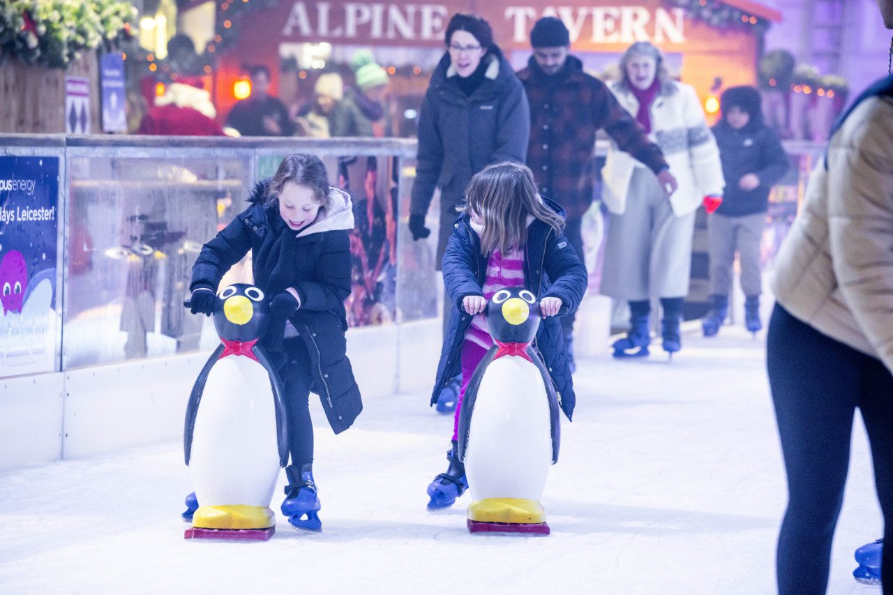 Girls with penguin skate aids