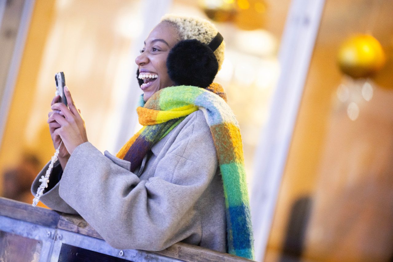 lady with ear muffs at ice rink